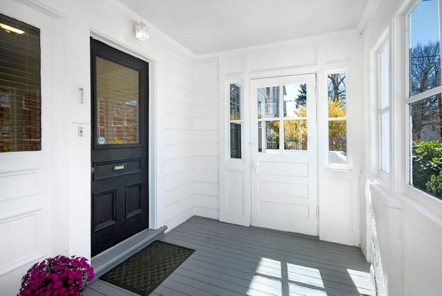 a view of an entryway with wooden floor