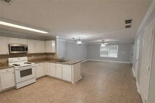 a kitchen with stainless steel appliances a stove sink and microwave