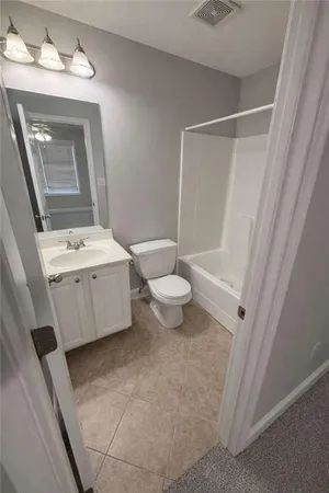 a bathroom with a double vanity sink mirror and toilet
