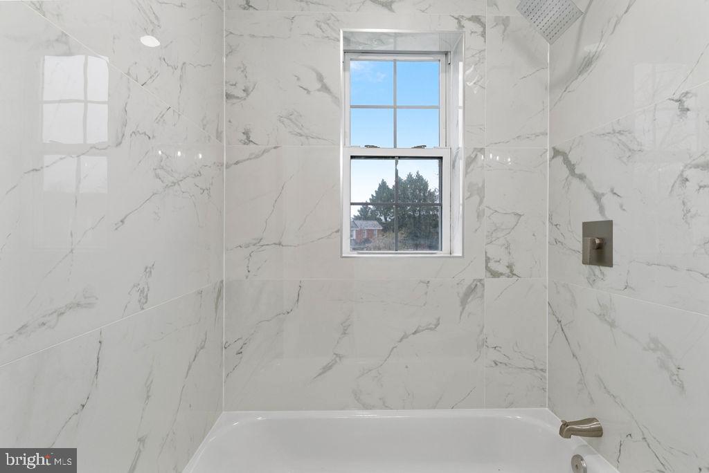 300 Denison Street Baltimore, MD 21229 - Photo 18 of 25 a bathroom with a bathtub and shower