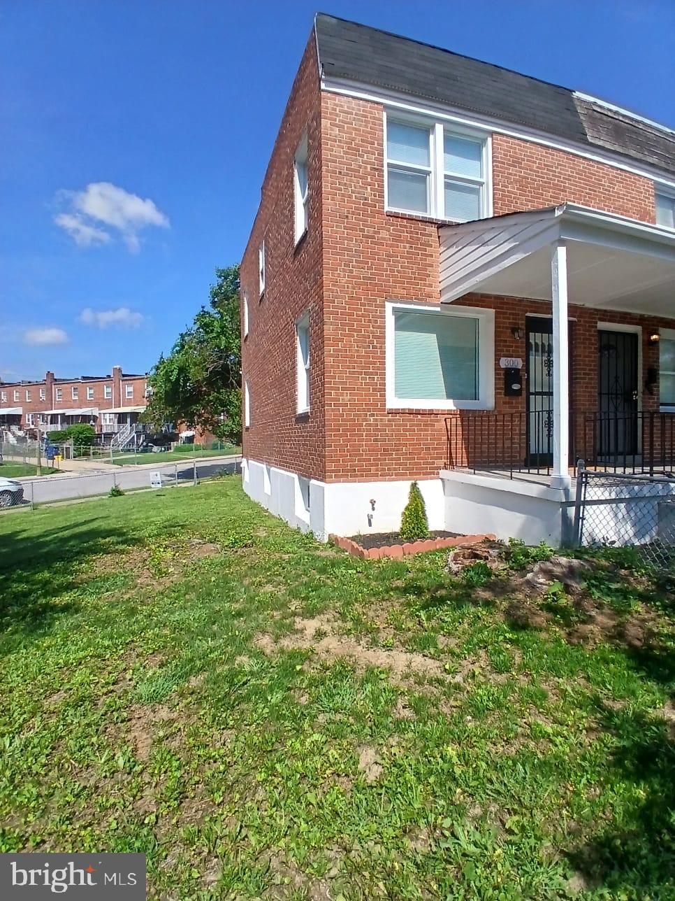 300 Denison Street Baltimore, MD 21229 - Photo 2 of 25 front view of a house with a yard