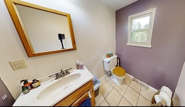 a bathroom with a sink mirror and vanity