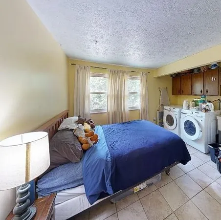 a bedroom with a bed and a microwave