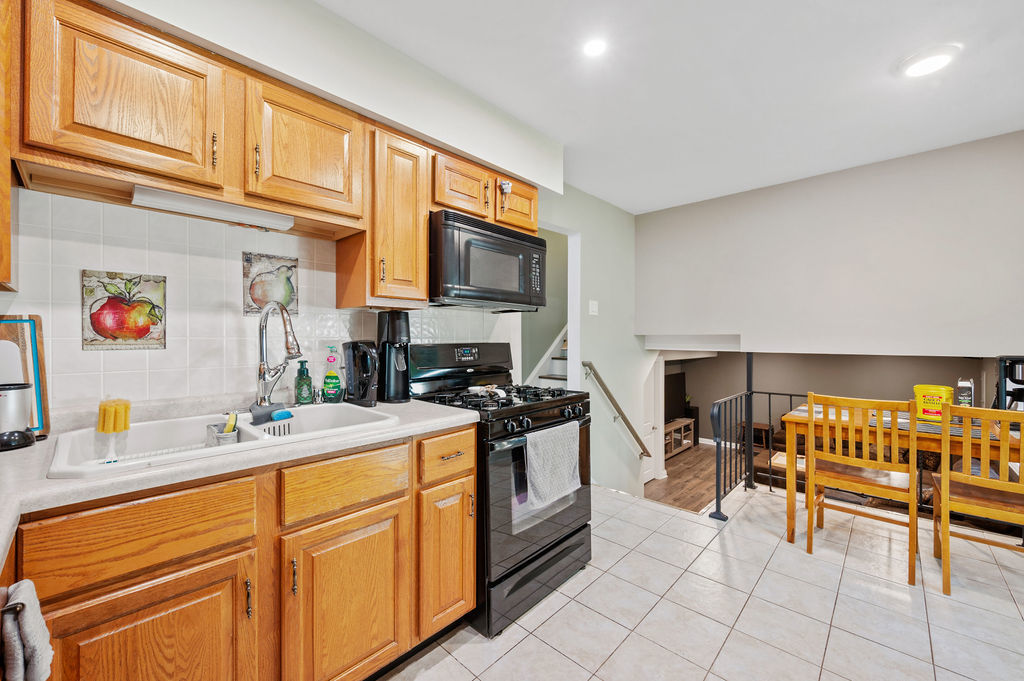537 West Stearns Road Bartlett, IL 60103 - Photo 11 of 30 a kitchen with stainless steel appliances granite countertop a sink and cabinets