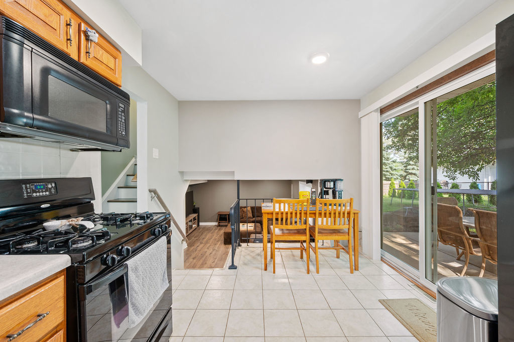 537 West Stearns Road Bartlett, IL 60103 - Photo 12 of 30 a kitchen with stainless steel appliances granite countertop a stove a sink and a microwave