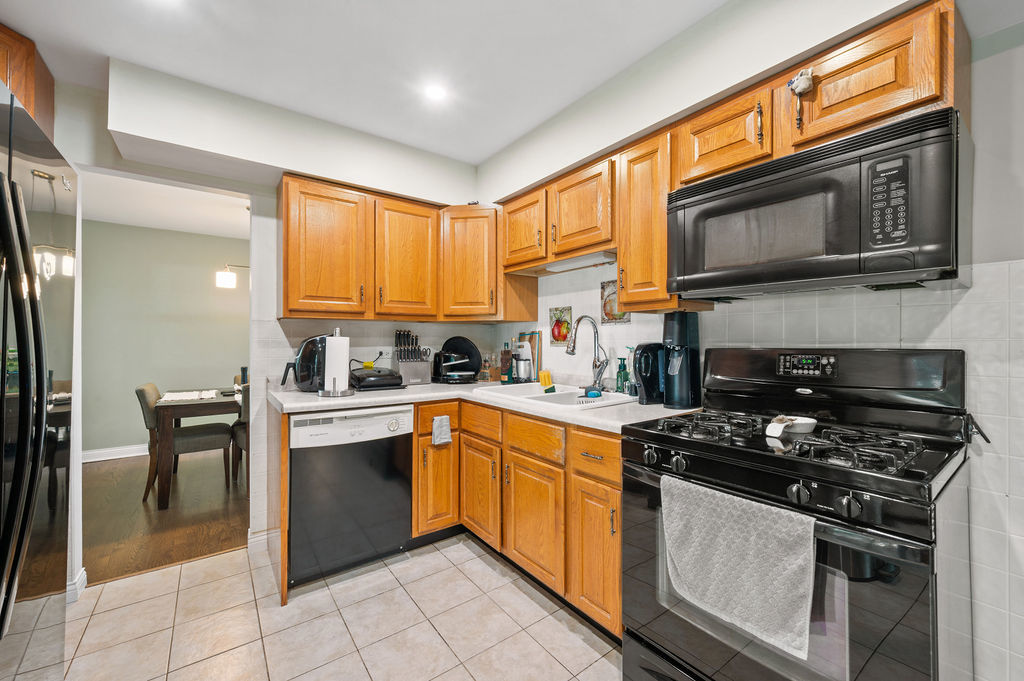537 West Stearns Road Bartlett, IL 60103 - Photo 13 of 30 a kitchen with stainless steel appliances granite countertop a stove a sink and a microwave