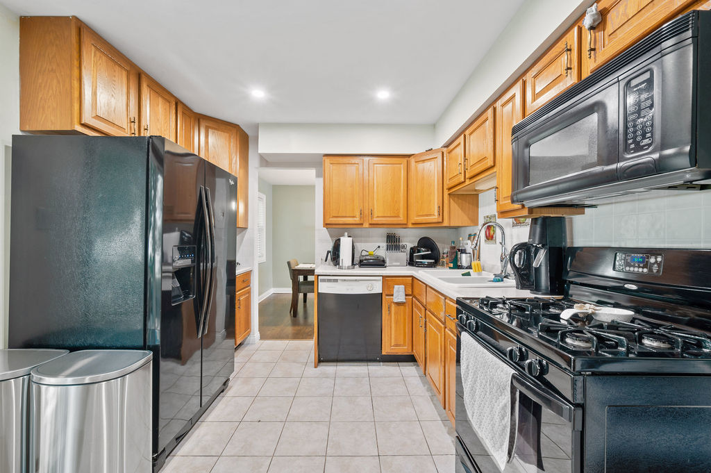 537 West Stearns Road Bartlett, IL 60103 - Photo 14 of 30 a kitchen with stainless steel appliances granite countertop a stove top oven a refrigerator and a sink