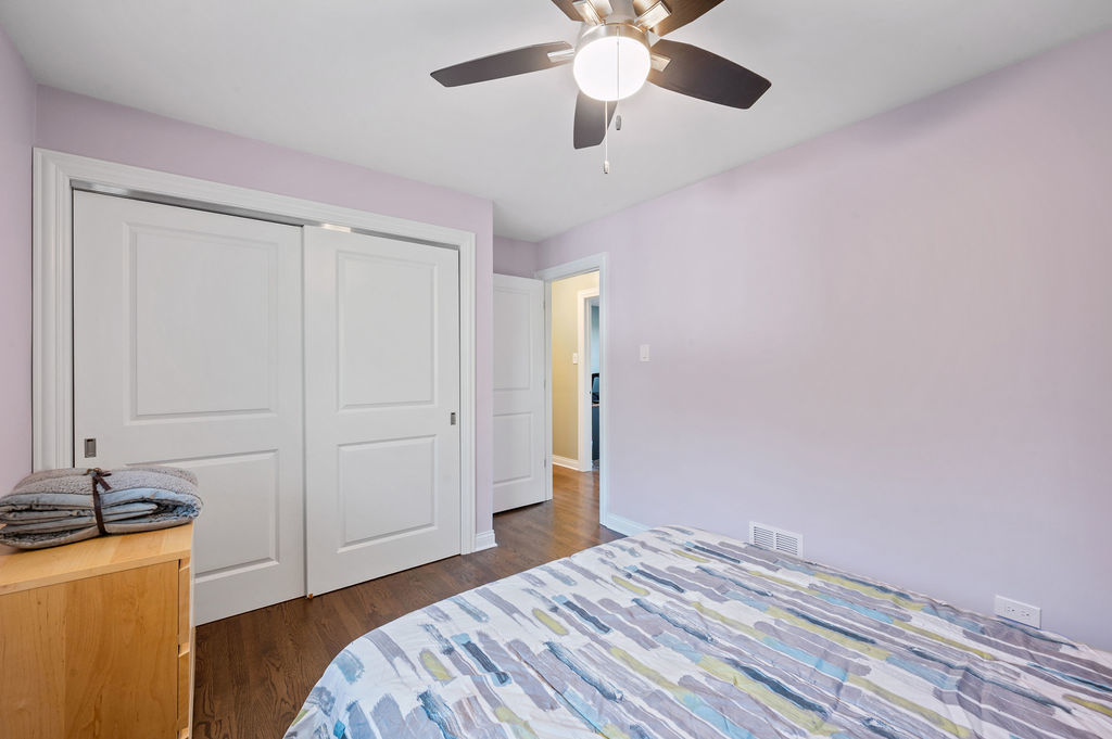 537 West Stearns Road Bartlett, IL 60103 - Photo 19 of 30 a bedroom with a bed and a chandelier