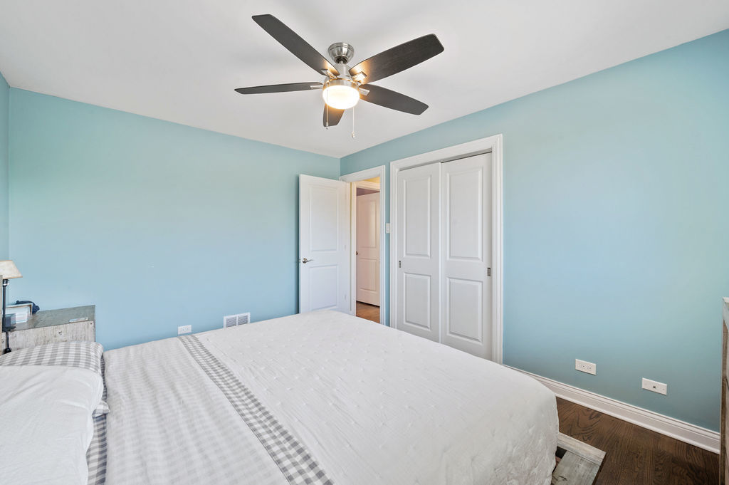 537 West Stearns Road Bartlett, IL 60103 - Photo 21 of 30 a bedroom with a large bed and a ceiling fan