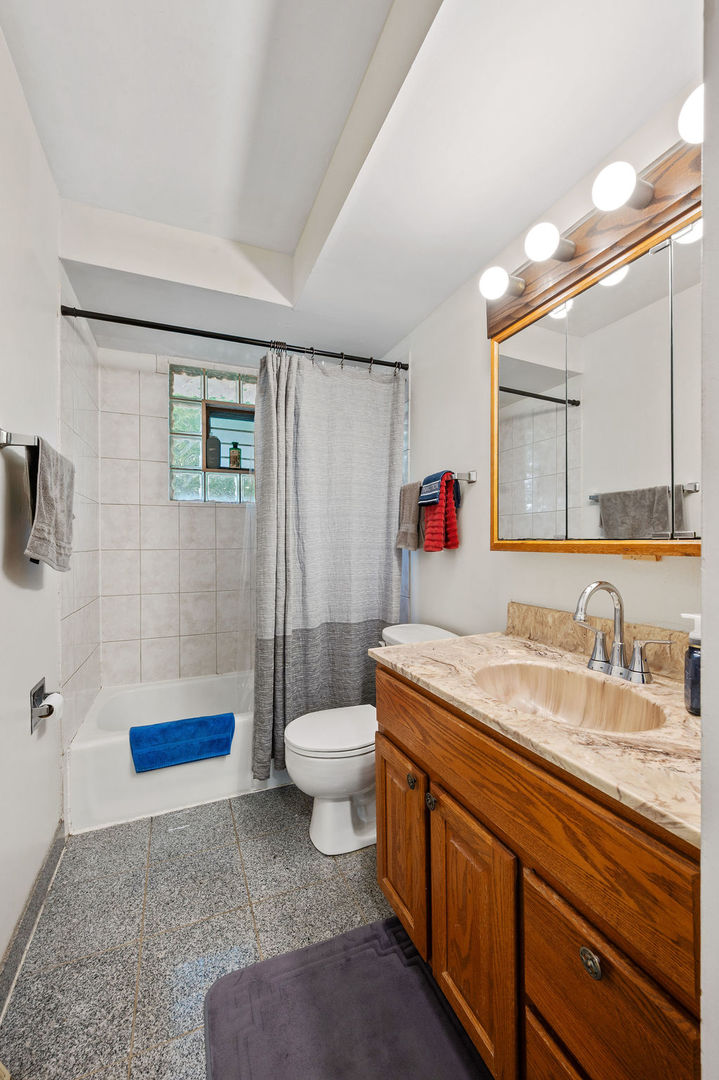 537 West Stearns Road Bartlett, IL 60103 - Photo 23 of 30 a bathroom with a granite countertop sink a toilet and a mirror