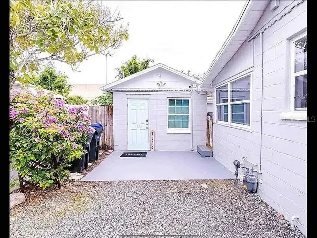 a living room with furniture a rug and white walls