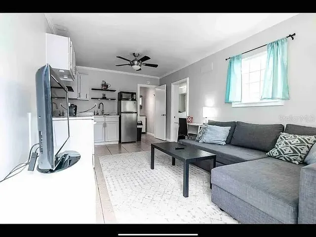 a living room with furniture and a flat screen tv