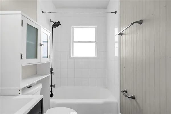 a bathroom with a bathtub and shower