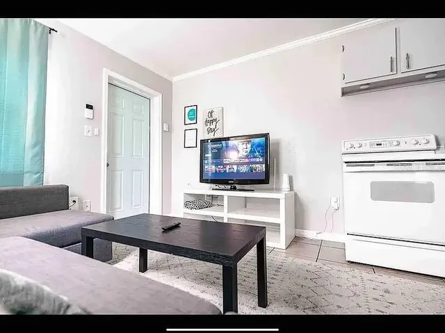 a kitchen with stainless steel appliances granite countertop a refrigerator sink stove and white cabinets