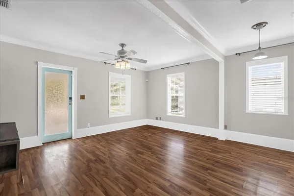 a living room with furniture a rug and white walls