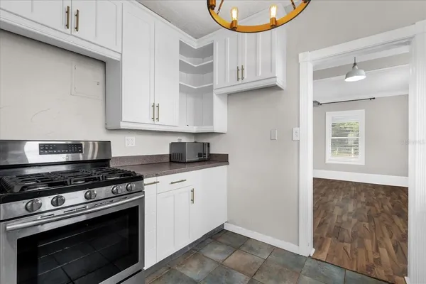 a kitchen with stainless steel appliances granite countertop a stove and a microwave