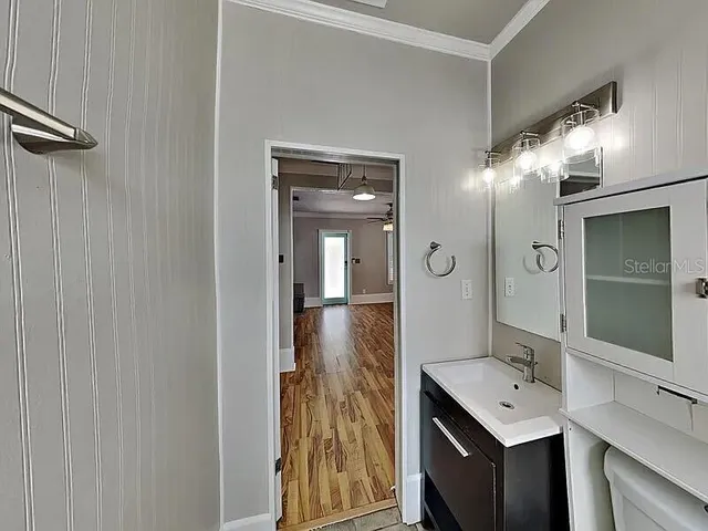 a bathroom with a shower sink and mirror