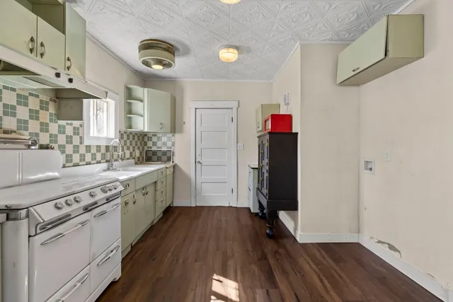 a kitchen with a sink and a refrigerator