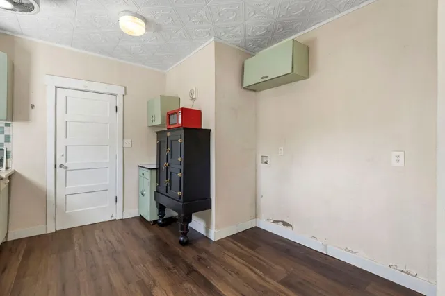 an empty room with wooden floor and closet