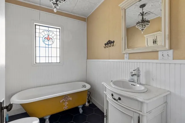 a bathroom with a sink a toilet and a mirror