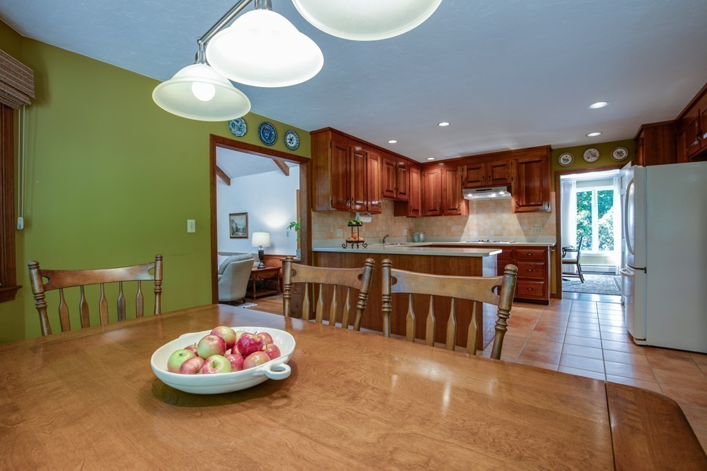 63 Monadnock Road Wellesley, MA 02481 - Photo 13 of 30 a kitchen with a refrigerator and a wooden floor