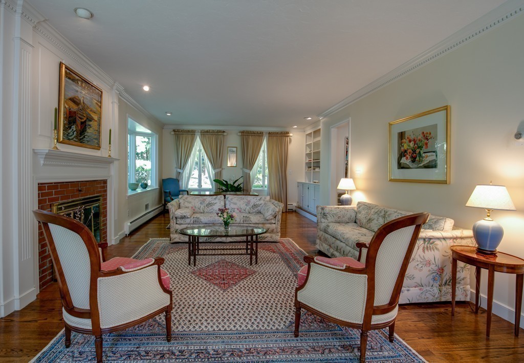 63 Monadnock Road Wellesley, MA 02481 - Photo 16 of 30 a living room with furniture a fireplace and a table