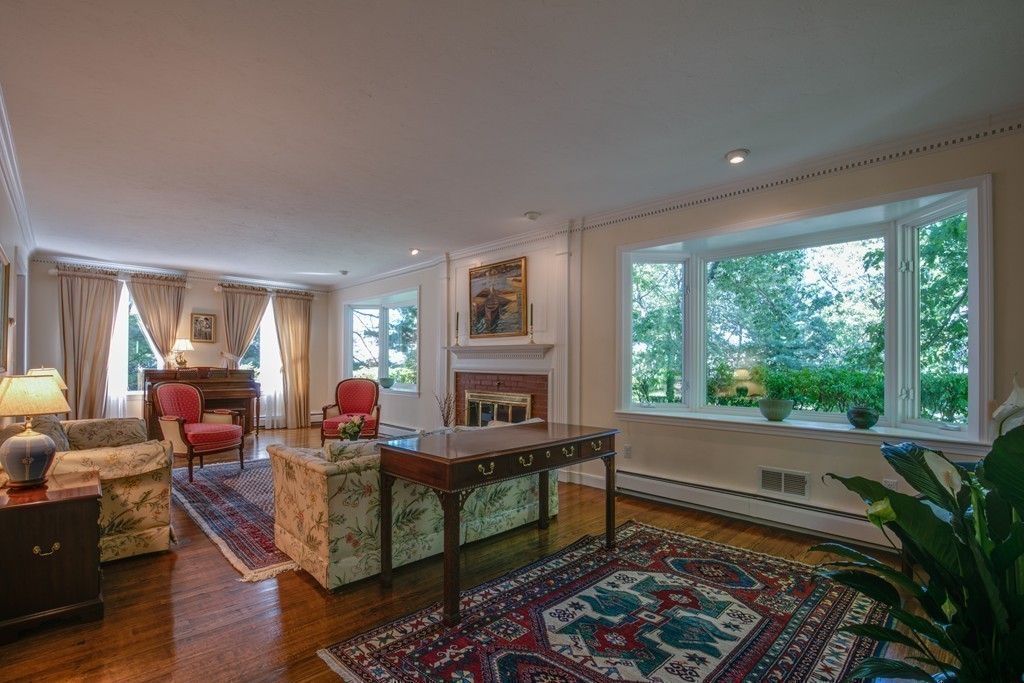 63 Monadnock Road Wellesley, MA 02481 - Photo 17 of 30 a living room with furniture fireplace and a large window