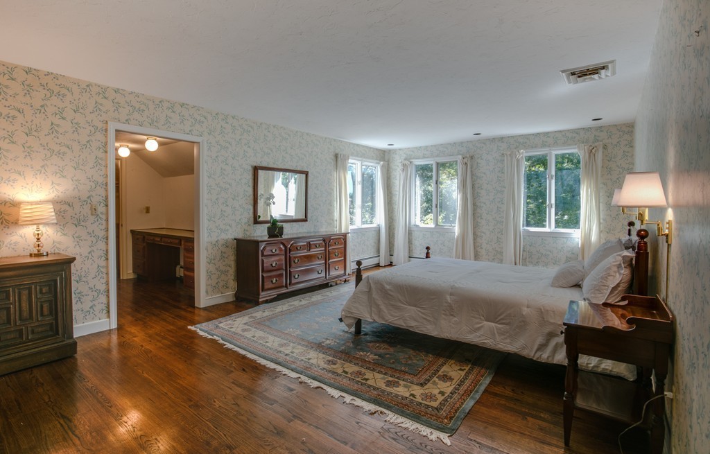 63 Monadnock Road Wellesley, MA 02481 - Photo 19 of 30 a bed room with a bed furniture and a flat screen tv