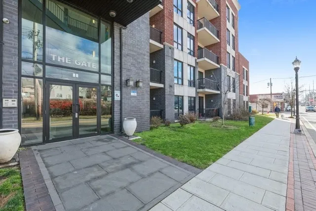 a view of a brick building next to a yard