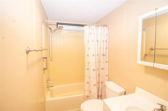 a bathroom with a shower and a toilet