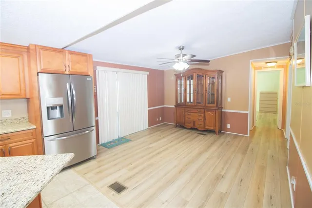 a view of a kitchen with a sink and refrigerator