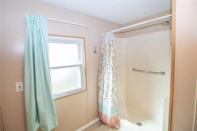 a bathroom with a glass shower door