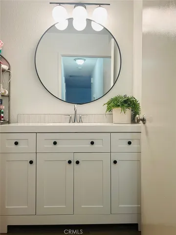 an empty room with wooden floor ceiling fan and windows