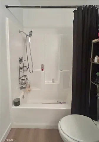 a view of room with hardwood floor and ceiling fan