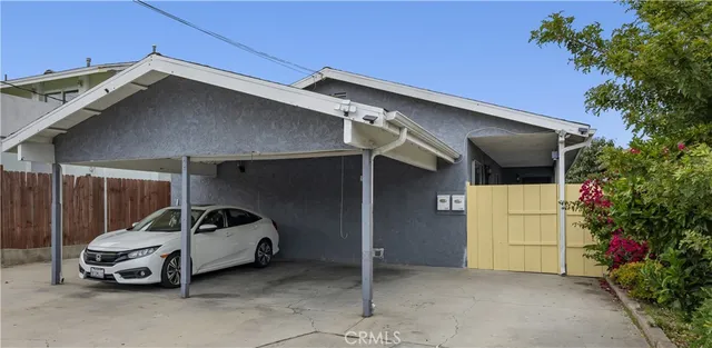 a view of kitchen island with stainless steel appliances a refrigerator and a counter