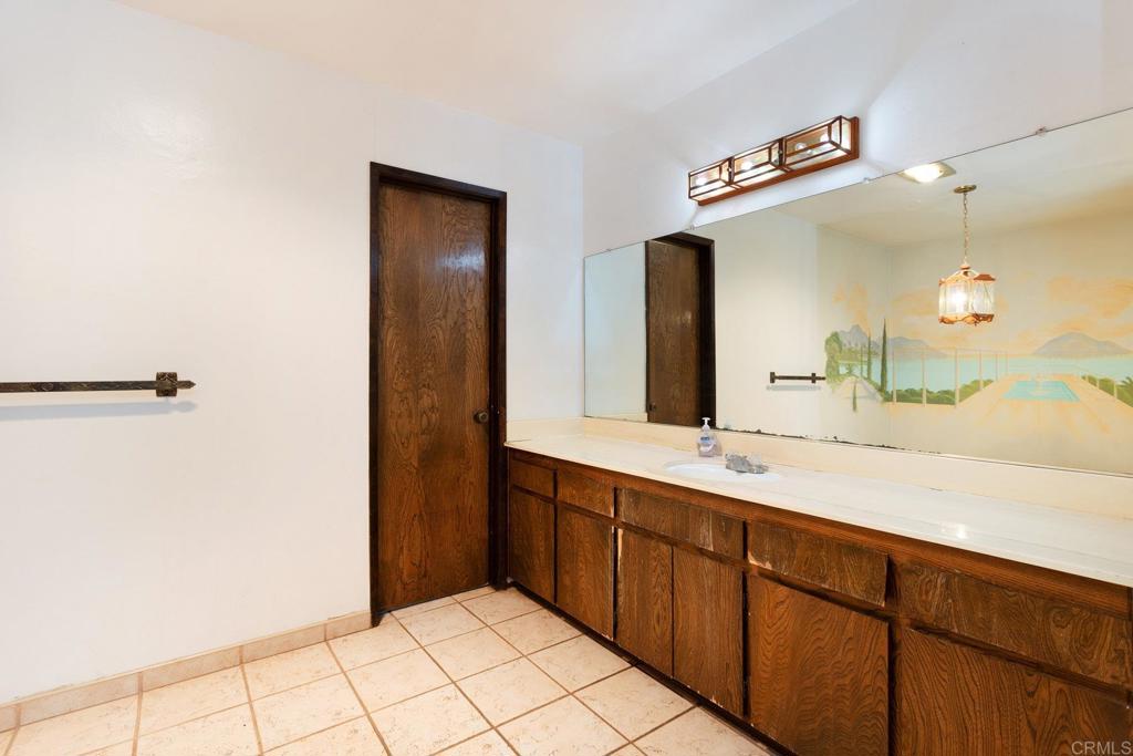 436 Mason Road Vista, CA 92084 - Photo 18 of 32 a bathroom with a sink a mirror and a shower