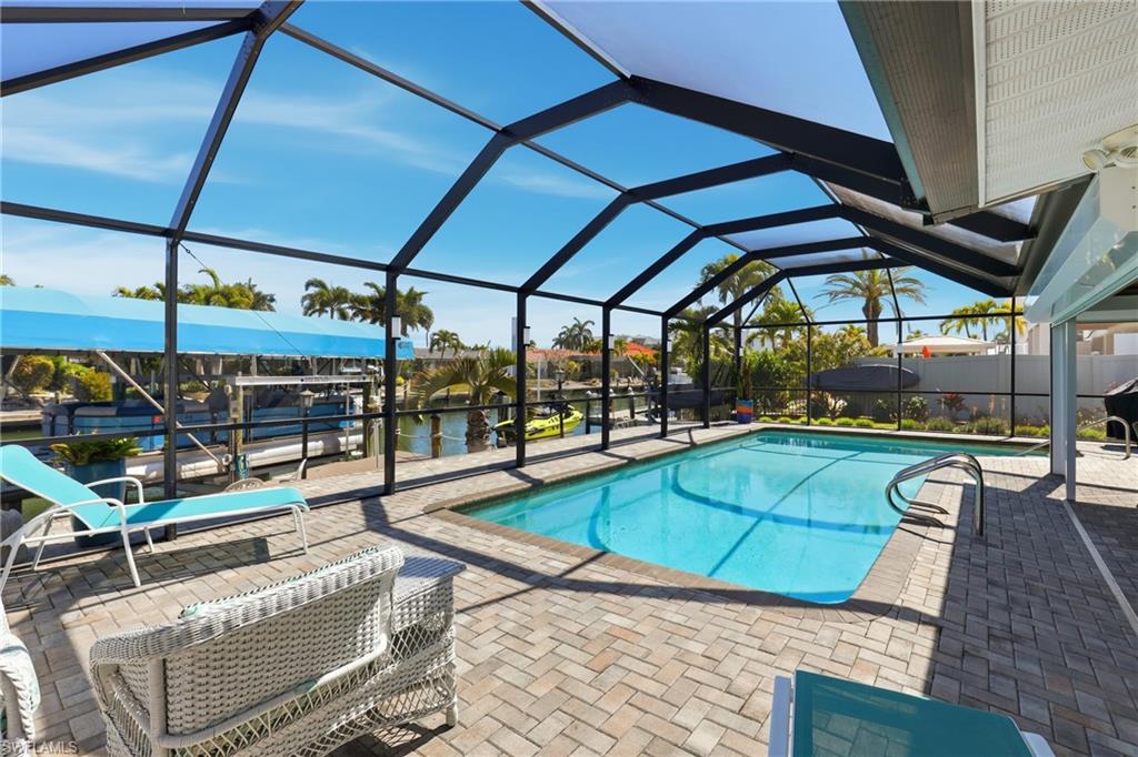 a view of a swimming pool with a lounge chairs