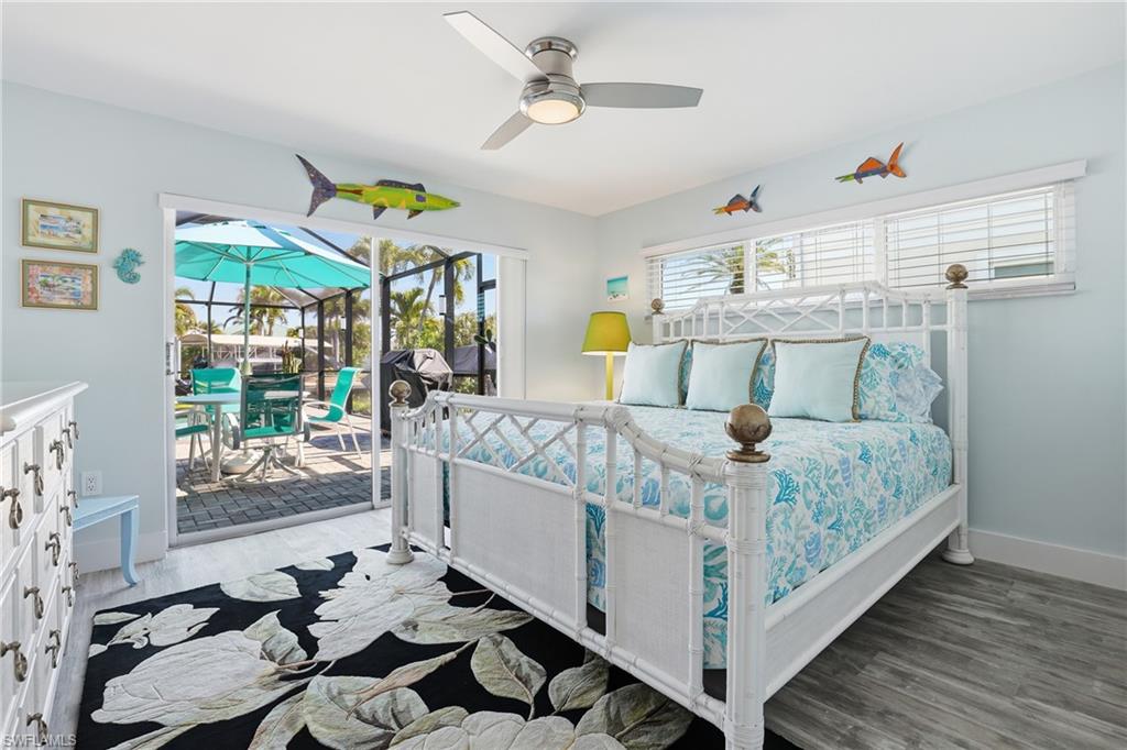 17 Palmview Boulevard Fort Myers Beach, FL 33931 - Photo 18 of 36 a bed sitting in a bedroom next to a window