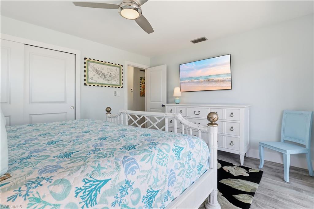 17 Palmview Boulevard Fort Myers Beach, FL 33931 - Photo 19 of 36 a bedroom with a bed and a desk