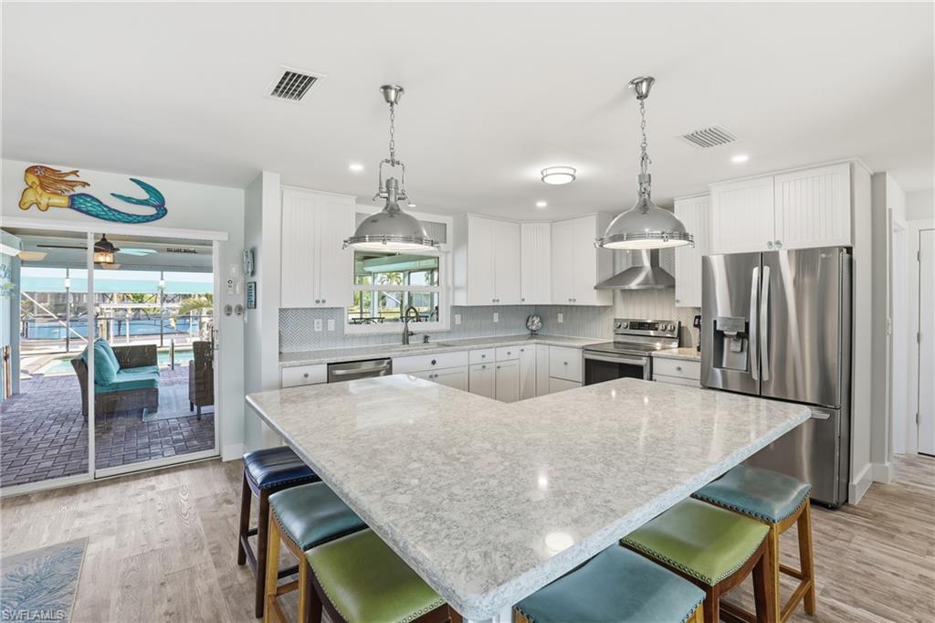 17 Palmview Boulevard Fort Myers Beach, FL 33931 - Photo 5 of 36 a large kitchen with a table and chairs
