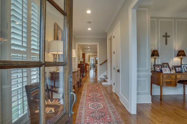 a view of an entryway with wooden floor and a livingroom view