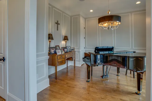 a view of entryway and dining room with wooden floor