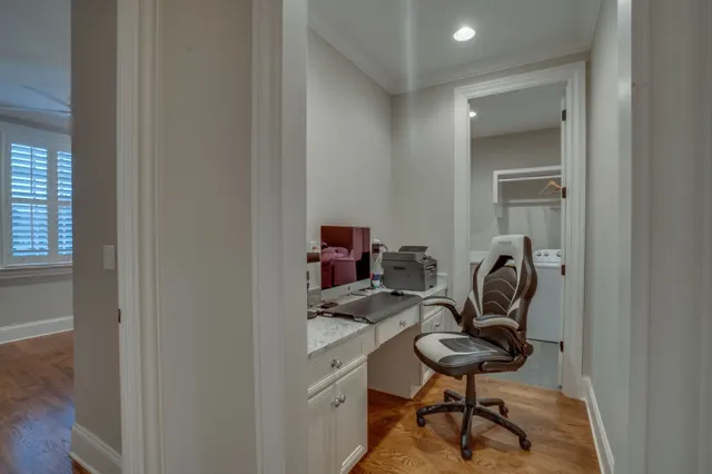 a view of a hallway with wooden floor