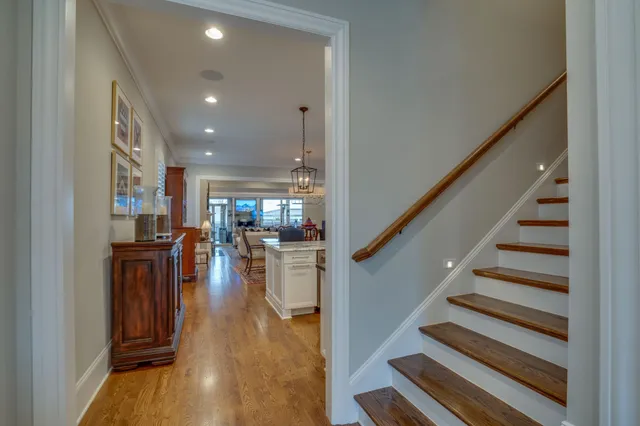 a kitchen with stainless steel appliances granite countertop a sink a stove and a wooden floors