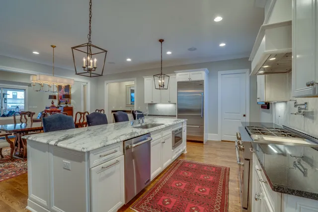 a kitchen with granite countertop cabinets stainless steel appliances and a window