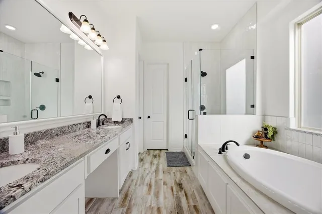 a bathroom with a tub sink and mirror
