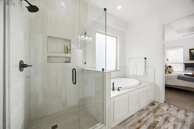 a bathroom with a tub sink and mirror