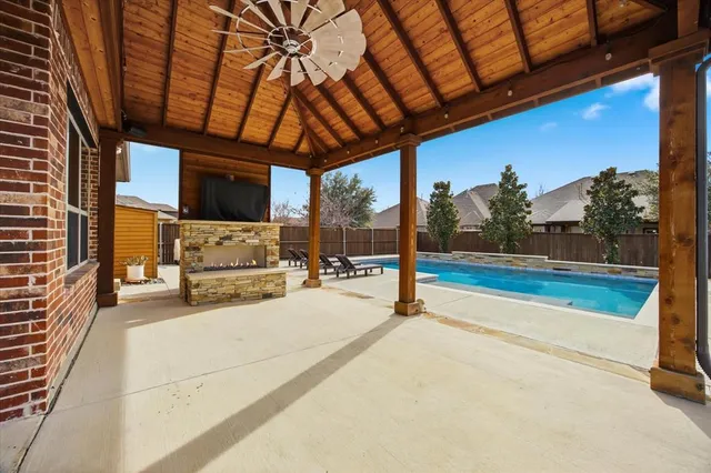 a view of swimming pool with a patio