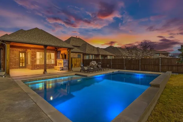 a view of a house with pool and a yard