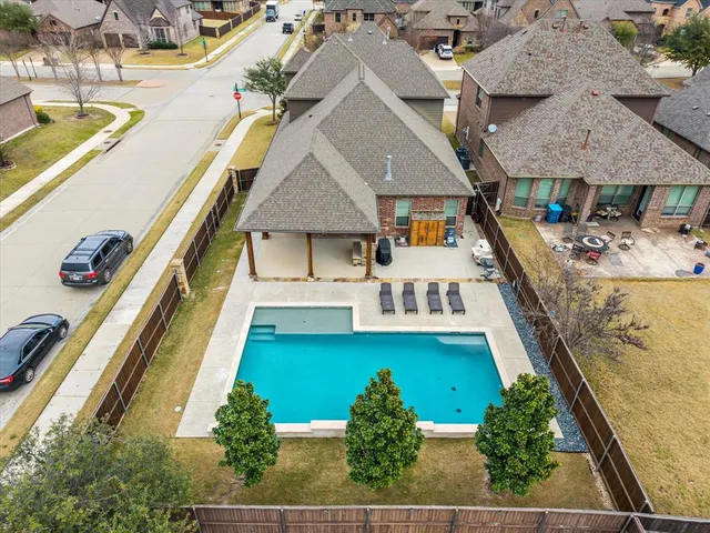 an aerial view of a house with a swimming pool